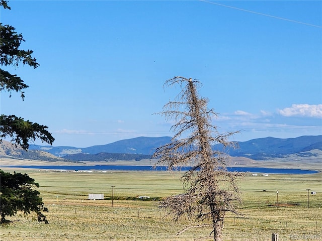 view of mountain feature with a water view and a rural view