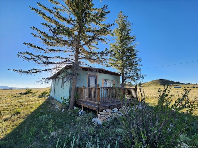 back of house featuring a deck with mountain view