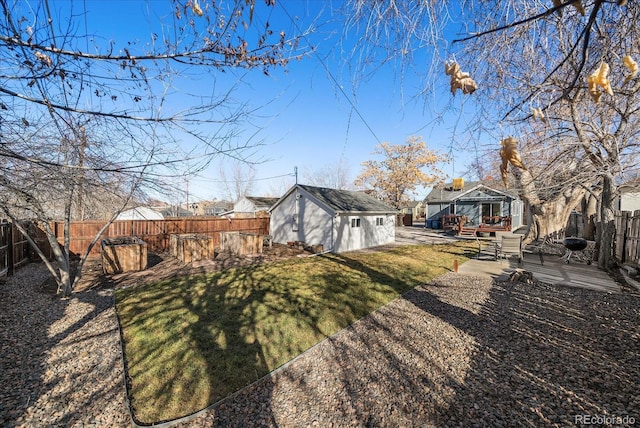 view of yard featuring an outbuilding, a patio area, and a fenced backyard