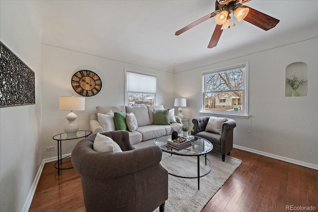 living room with wood finished floors, a ceiling fan, and baseboards