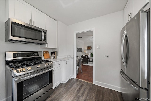 kitchen with dark wood-style floors, white cabinetry, and stainless steel appliances