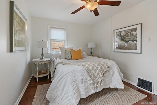 bedroom featuring ceiling fan, wood finished floors, visible vents, and baseboards