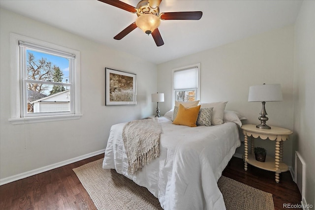 bedroom featuring ceiling fan, baseboards, and wood finished floors