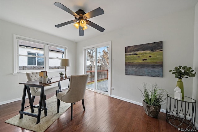 office area featuring a ceiling fan, baseboards, and wood finished floors