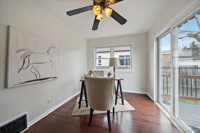 dining room featuring wood finished floors, visible vents, and baseboards