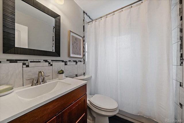 bathroom with tile walls, tasteful backsplash, a shower with shower curtain, toilet, and vanity