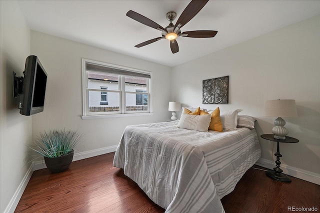 bedroom with ceiling fan, wood finished floors, and baseboards