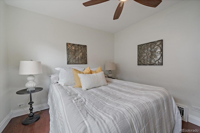 bedroom featuring visible vents, baseboards, and wood finished floors