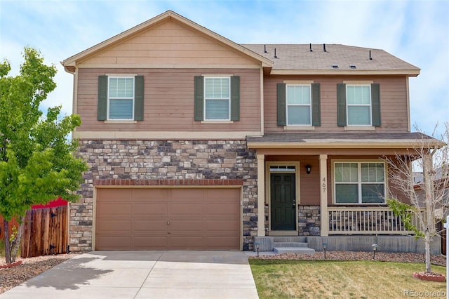 467 S 36th Ave, Brighton, CO 80601 - view of front of home with stone siding, covered porch, an attached garage, concrete driveway, and a shingled roof