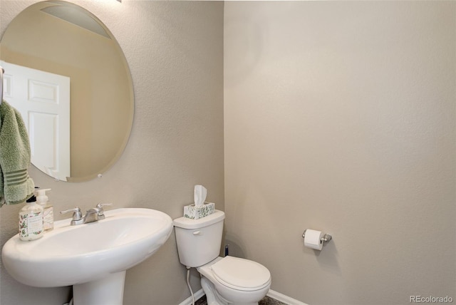 467 S 36th Ave, Brighton, CO 80601 - bathroom with a sink, toilet, and baseboards