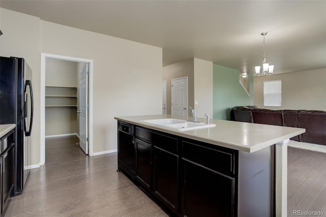 467 S 36th Ave, Brighton, CO 80601 - kitchen with a sink, black appliances, dark wood finished floors, light countertops, and open floor plan