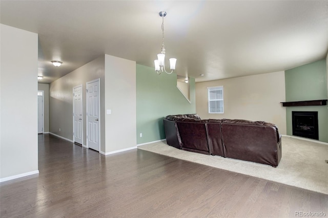 467 S 36th Ave, Brighton, CO 80601 - living room featuring wood finished floors, a chandelier, baseboards, and a fireplace