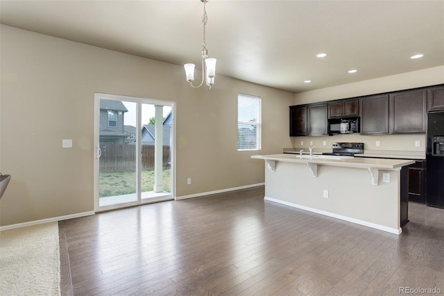 467 S 36th Ave, Brighton, CO 80601 - kitchen featuring black appliances, healthy amount of natural light, light countertops, a chandelier, and recessed lighting