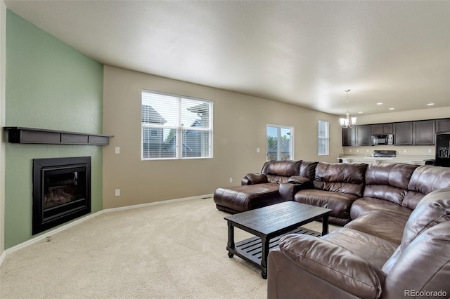 467 S 36th Ave, Brighton, CO 80601 - living area featuring a chandelier, light colored carpet, a glass covered fireplace, baseboards, and recessed lighting
