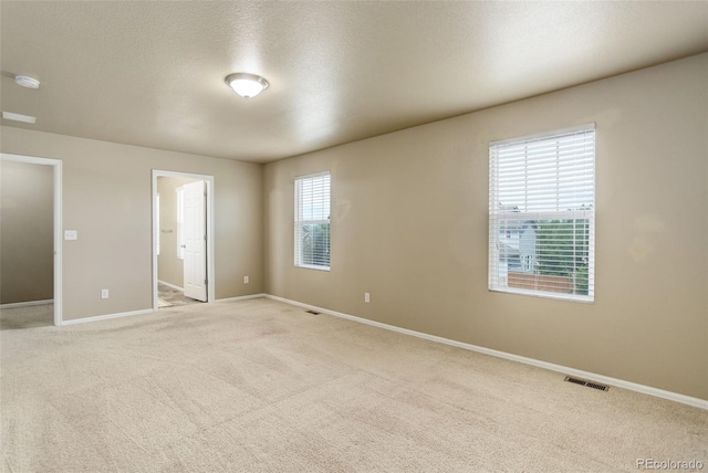 467 S 36th Ave, Brighton, CO 80601 - unfurnished bedroom with baseboards, light colored carpet, a textured ceiling, and ensuite bath