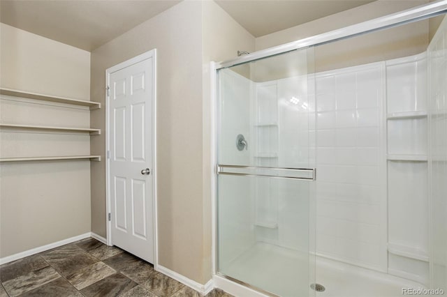467 S 36th Ave, Brighton, CO 80601 - full bathroom with baseboards, a shower stall, and stone finish floors