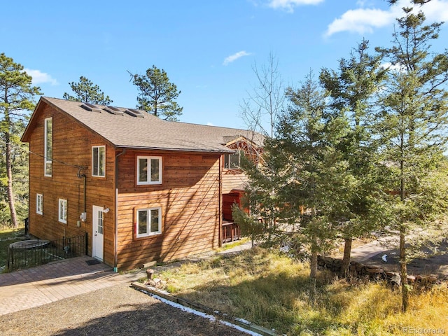28730 Mountain View Rd, Conifer, CO 80433 - view of side of property featuring a shingled roof and driveway