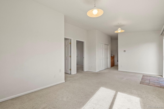 spare room with light colored carpet