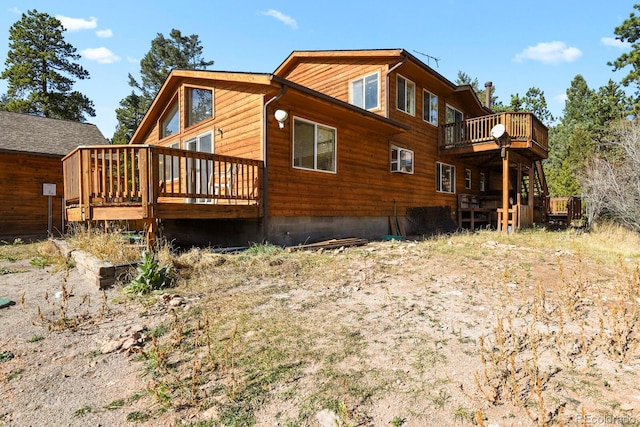 rear view of house featuring a deck and a balcony