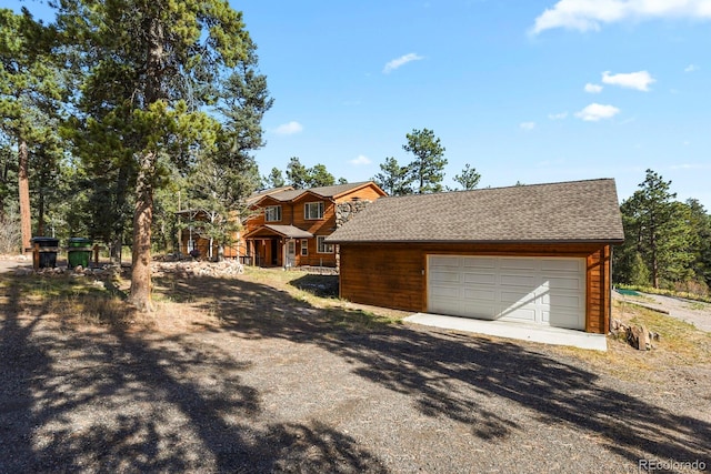 view of front of property featuring a garage and an outbuilding