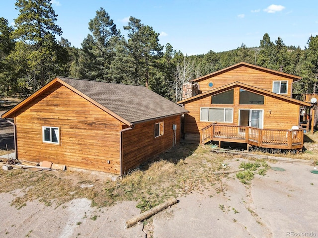 28730 Mountain View Rd, Conifer, CO 80433 - view of front of house with a deck and a shingled roof