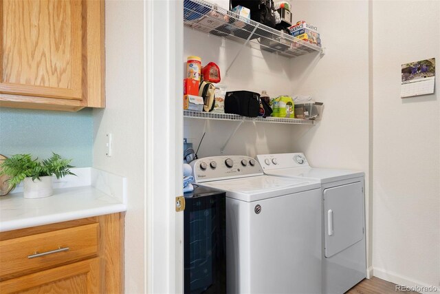 5735 N Genoa Way Unit 11-205, Aurora, CO 80019 - laundry room with cabinet space, baseboards, and washing machine and dryer