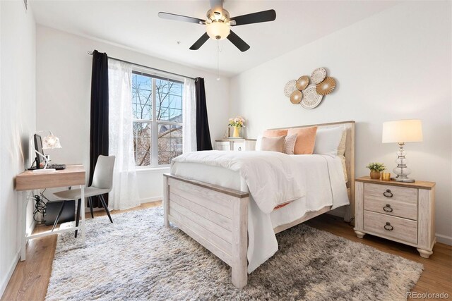 5735 N Genoa Way Unit 11-205, Aurora, CO 80019 - bedroom with a ceiling fan, baseboards, and wood finished floors