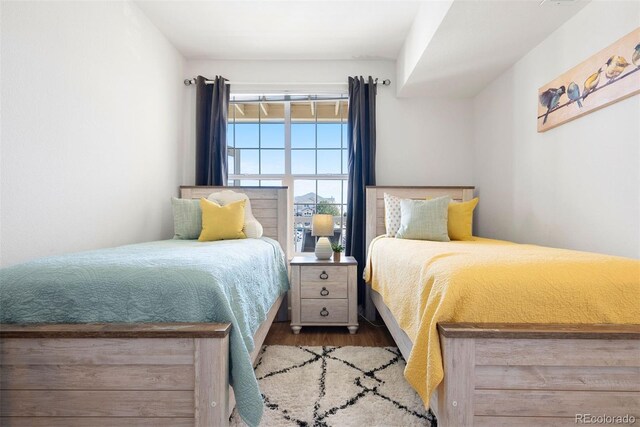 5735 N Genoa Way Unit 11-205, Aurora, CO 80019 - bedroom featuring wood finished floors