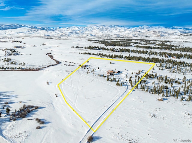 snowy aerial view with a mountain view