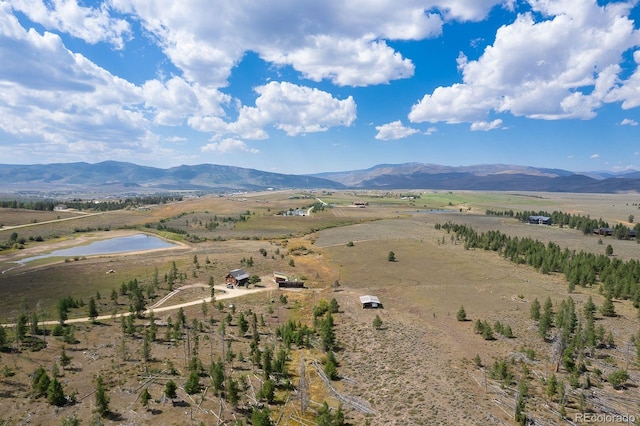 birds eye view of property featuring a mountain view and a rural view