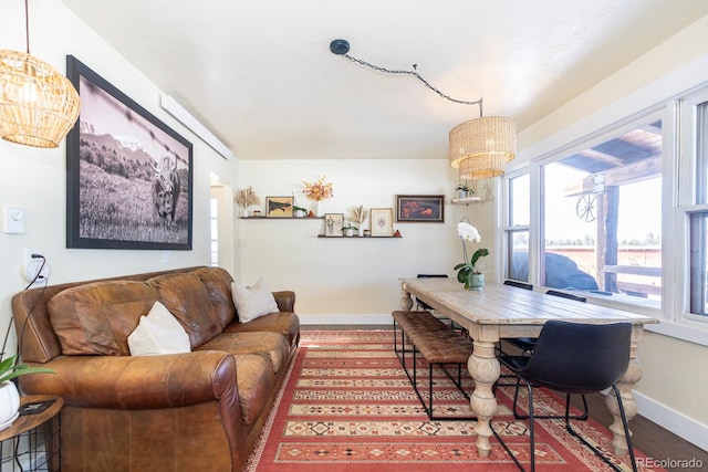 dining area featuring a wealth of natural light, an inviting chandelier, and wood-type flooring