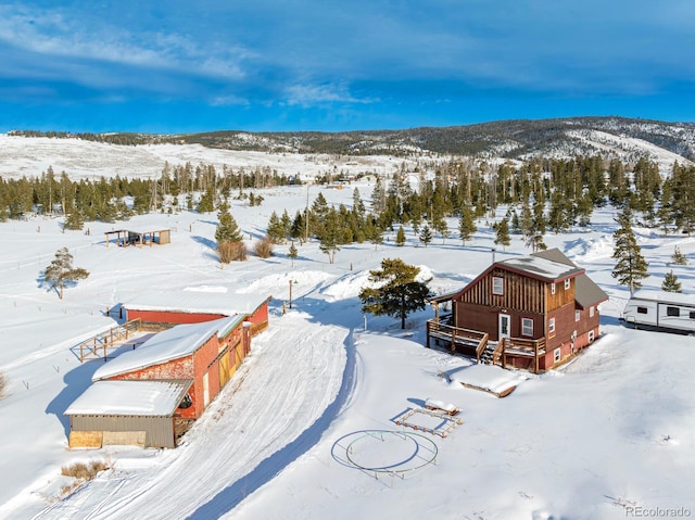 snowy aerial view with a mountain view