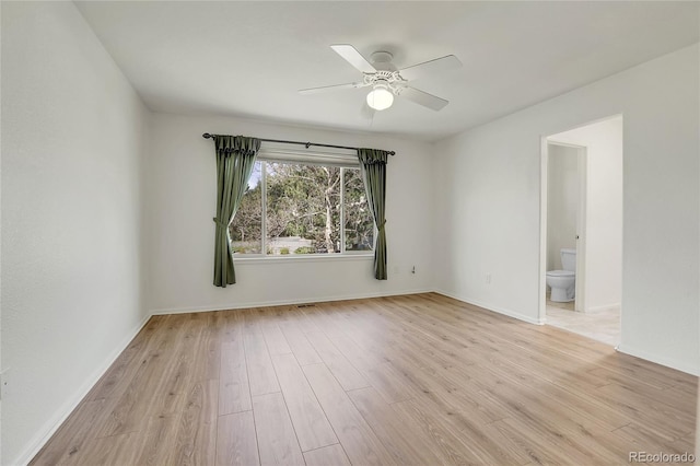 spare room with light wood-style flooring, ceiling fan, and baseboards