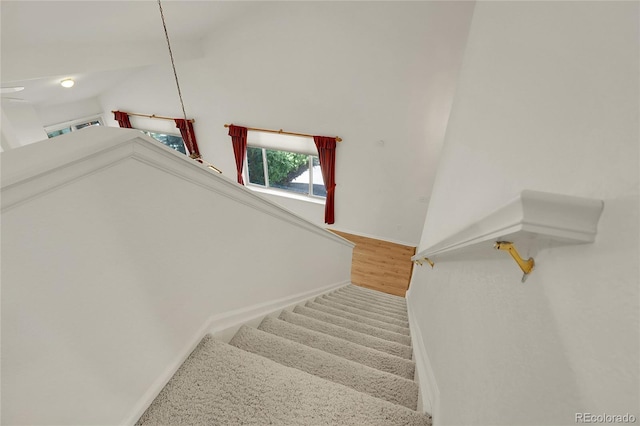 stairway featuring baseboards and wood finished floors