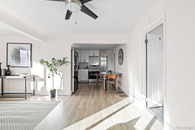 interior space with ceiling fan and light hardwood / wood-style floors