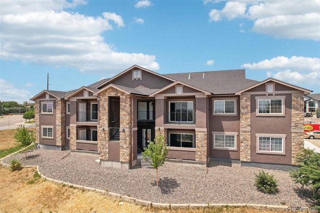 view of front of house with stone siding and stucco siding