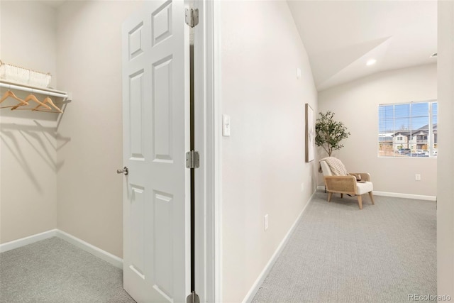 hall with lofted ceiling, recessed lighting, carpet, and baseboards