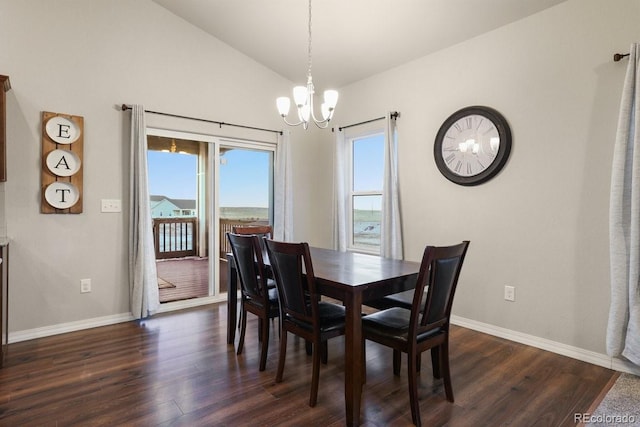 dining area featuring dark hardwood / wood-style floors, vaulted ceiling, and a notable chandelier