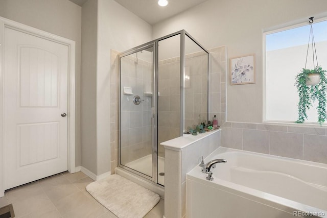 bathroom featuring tile patterned floors and separate shower and tub