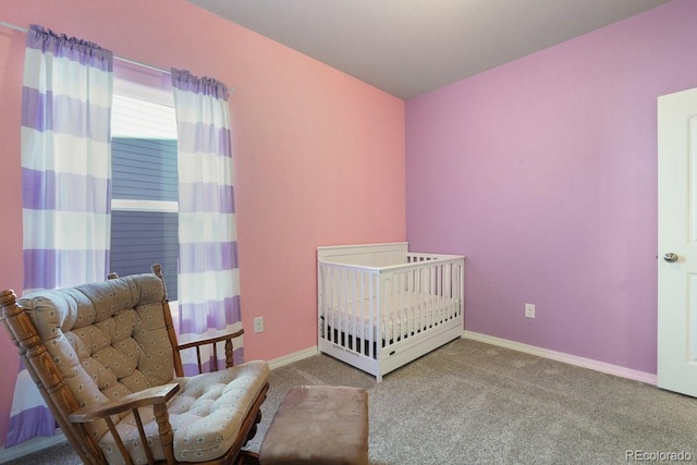 carpeted bedroom featuring a crib