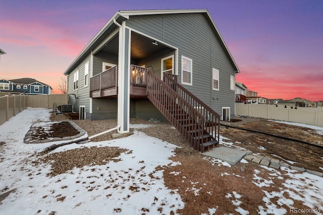 snow covered house with central AC