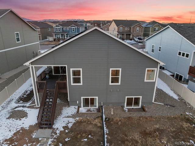 view of snow covered rear of property