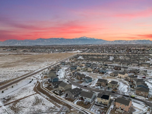 snowy aerial view featuring a mountain view