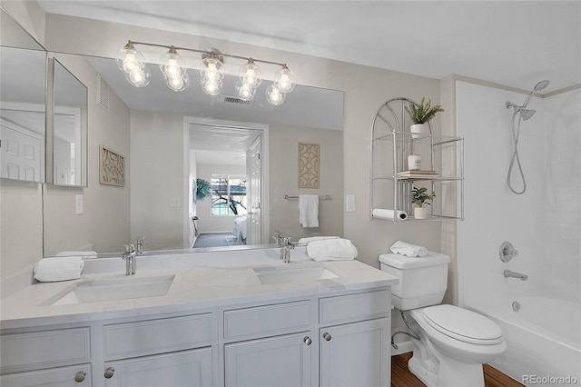 ensuite bathroom featuring double vanity, visible vents, shower / washtub combination, and a sink