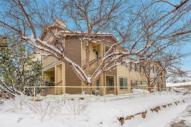 view of snow covered exterior featuring a balcony