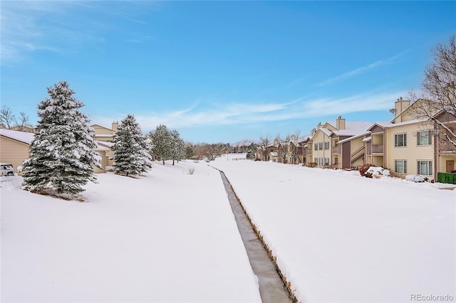 snowy yard with a residential view