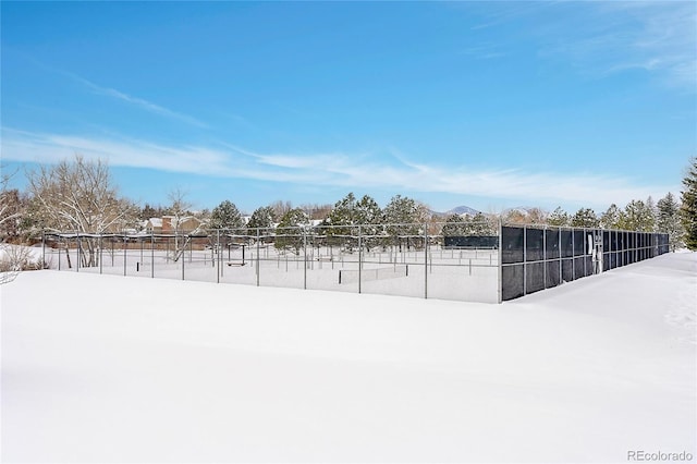 yard layered in snow with fence