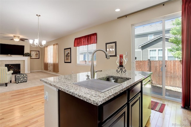12513 Grape St, Thornton, CO 80241 - kitchen with dishwasher, open floor plan, light wood finished floors, pendant lighting, and light stone countertops