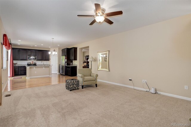 12513 Grape St, Thornton, CO 80241 - living area with light carpet, a chandelier, ceiling fan, recessed lighting, and healthy amount of natural light
