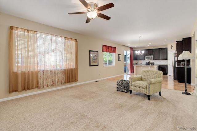 12513 Grape St, Thornton, CO 80241 - living area with light carpet, a ceiling fan, recessed lighting, and a chandelier